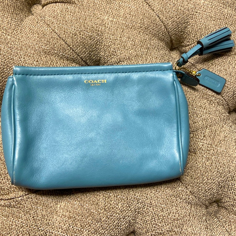 Beautifully blue Coach clutch with tassel. In great condition.